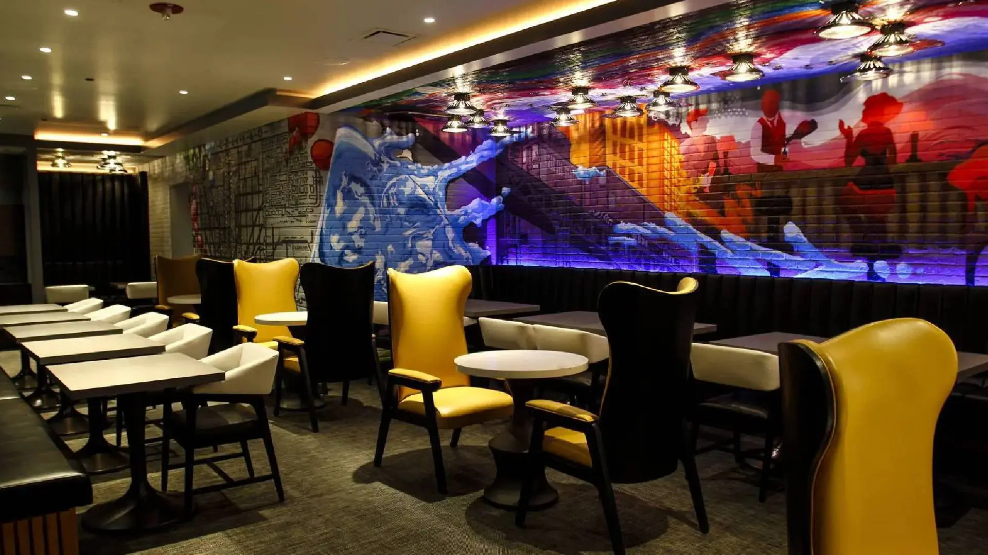 Modern dining area with colorful wall art and stylish chairs.