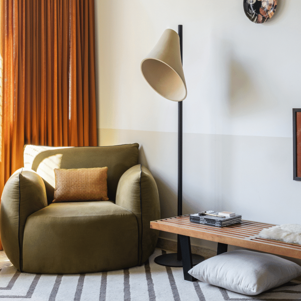 Cozy living room with an olive green armchair and floor lamp.