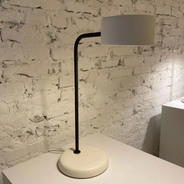 Modern desk lamp with a gray shade on a white base.