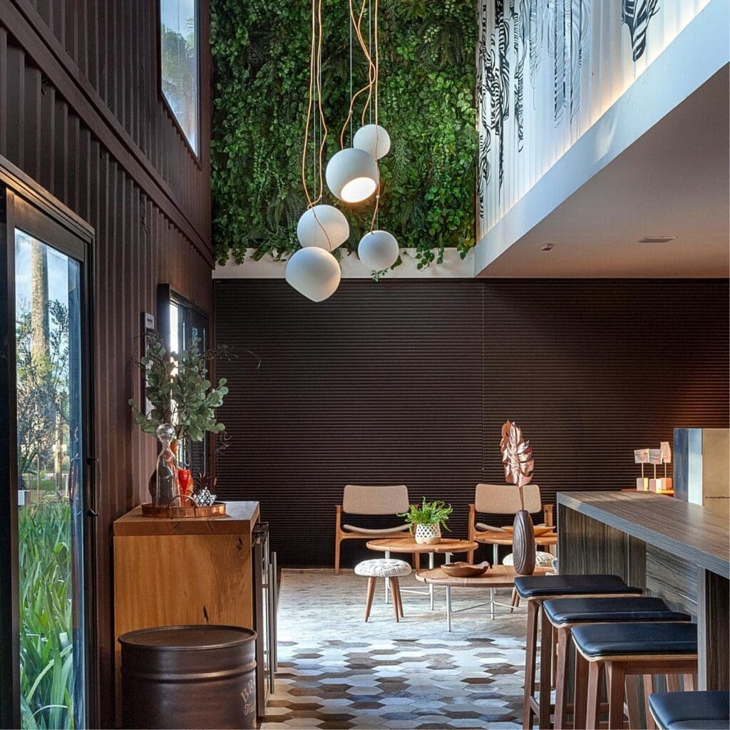 Cozy modern living space with wooden furniture and hanging lights.