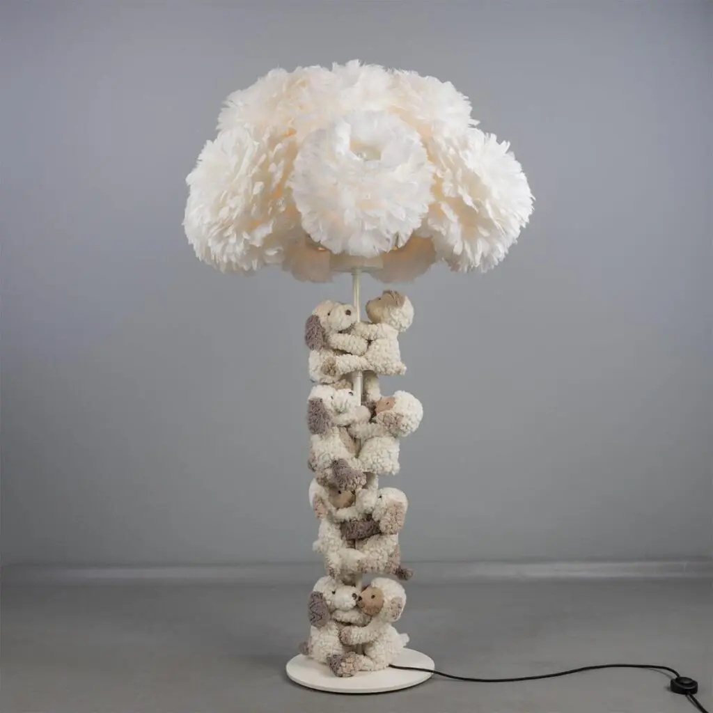 Unique lamp with a cloud-like fluffy shade and a base made of stacked animal figurines.